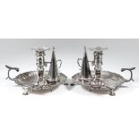 A pair of early George III silver circular chamber candlesticks the moulded rims with C-scroll and