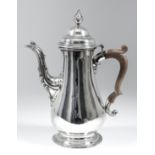 A George III plain silver baluster shaped coffee pot, the domed cover with cast pineapple finial and