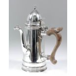 A George VI silver side handeld coffee pot of "early 18th Century" design, the domed cover with