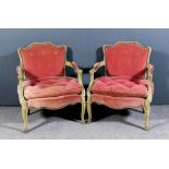 A pair of French cream painted low fauteuil of "Louis XV" design with moulded showwood and shaped