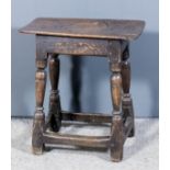 A 17th Century oak joint stool with plain top, on baluster turned legs and plain stretchers, 19.