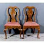 A pair of early 18th Century fruitwood dining chairs, the shaped backs with solid vase pattern