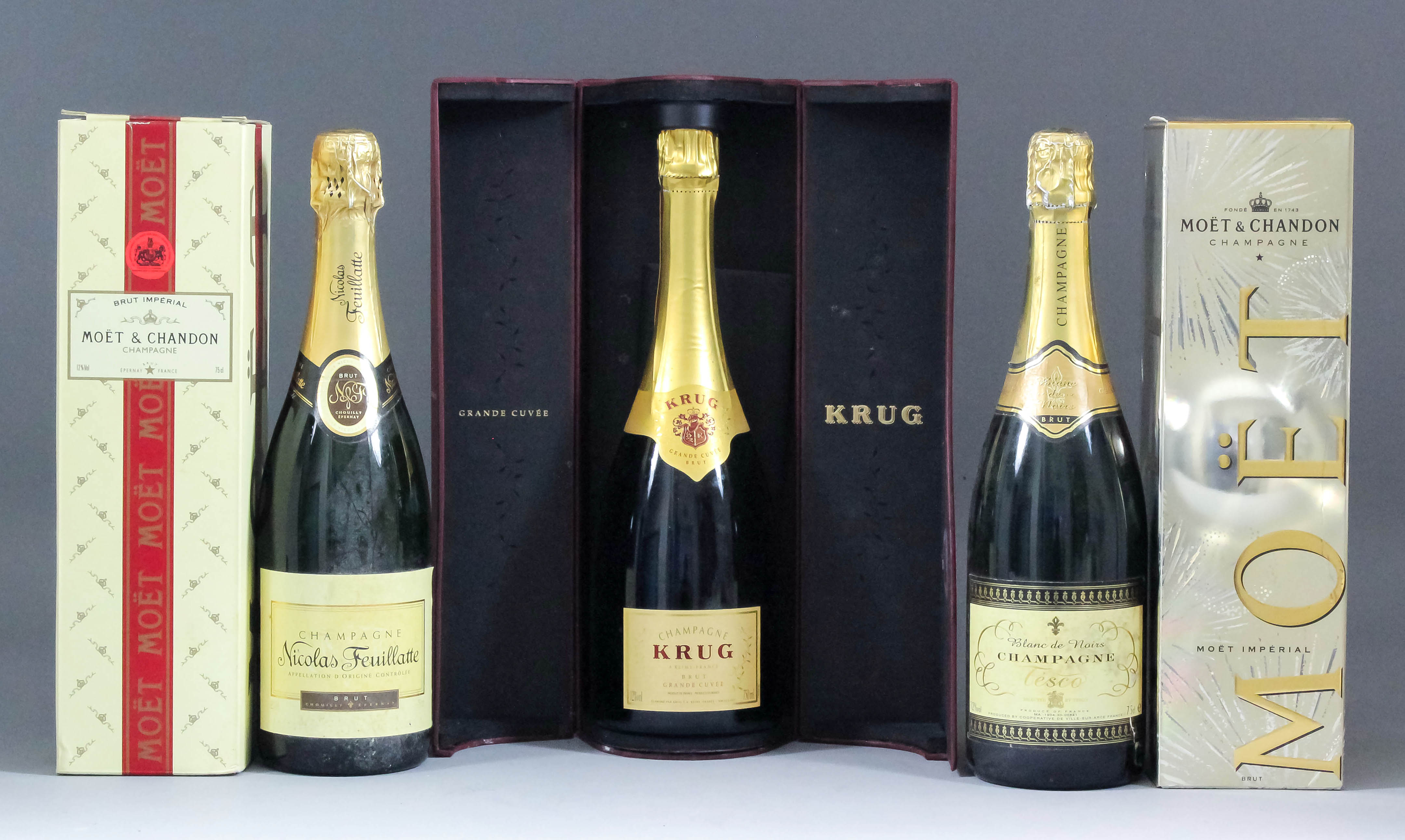 Five bottles of Champagne, including - a bottle of Krug "Grand Cuvee" in original box, two Moet et