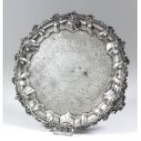 An early Victorian silver circular salver, the shaped and moulded rim cast with scroll and shell