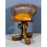 A 19th Century Italian walnut "Grotto" stool with carved shell pattern swivel seat, on three bold