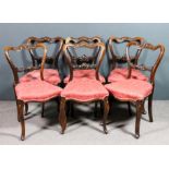 A set of six early Victorian rosewood drawing room chairs, the shaped crest rails carved with vacant