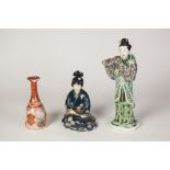 AN EARLY 20TH CENTURY JAPANESE ARITA PORCELAIN FIGURE of a female deity holding a lotus branch on