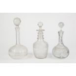 THREE NINETEENTH CENTURY AND LATER CUT GLASS DECANTERS WITH STOPPERS, including one with triple