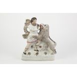 NINETEENTH CENTURY STAFFORDSHIRE FLAT BACK PEARLWARE POTTERY GROUP OF DANIEL AND THE LION, painted