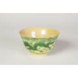 A SMALL CHINESE PORCELAIN BOWL , THE BODY INCISED AND ENAMELLED ON THE BISCUIT IN YELLOW AND