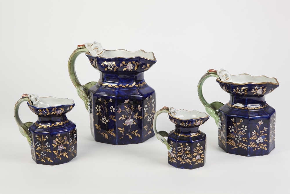 SET OF FOUR CIRCA 1830 STAFFORDSHIRE POTTERY OCTAGONAL JUGS, with 'dragon' handles, the royal blue