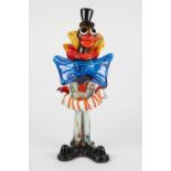 MODERN MURANO COLOURED GLASS FIGURE OF A CLOWN, modelled standing playing a squeeze box, 16 ½" (41.
