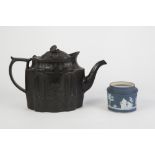 PROBABLY WEDGWOOD, LATE EIGHTEENTH CENTURY MOULDED BLACK BASALT POTTERY TEAPOT, of shaped oval
