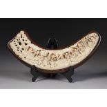 A LATE 19TH CENTURY CHINESE CANTON CARVED IVORY WRIST REST of flattened semi-circular form carved in
