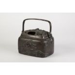 A JAPANESE MEIJI PERIOD BRONZE INCENSE BURNER WITH BAIL HANDLE, the rounded oblong body cast in