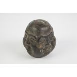 A CURIOUS ORIENTAL PATINATED COPPER ALLOY WEIGHT of rounded square form, on each side a different