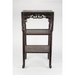 A LATE 19TH CENTURY CHINESE HARDWOOD THREE TIER STAND with marble inset top, having a scroll