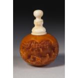 CHINESE 19TH CENTURY CARVED AMBER AND IVORY ORBICULAR SNUFF BOTTLE with opposing deeply carved