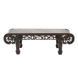 A LATE 19TH/EARLY 20TH CENTURY CHINESE HARDWOOD LOW TABLE WITH SCROLL ENDS, the frieze pierced and