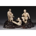 A FINE JAPANESE MEIJI PERIOD SECTIONAL CARVED IVORY AND WOODEN OKIMONO OF A MOTHER, FATHER, AND