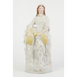 NINETEENTH CENTURY STAFFORDSHIRE POTTERY FIGURE OF 'RUTH', heightened in yellow and gilt and