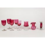 EIGHT PIECES OF CRANBERRY GLASS, comprising: SIX STEMMED DRINKING GLASSES, JUG, and a KNIFE REST/