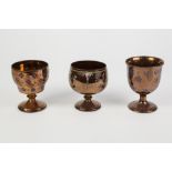 THREE NINETEENTH CENTURY WELL POTTED COPPER LUSTRE GOBLETS, various, one over painted with flowers