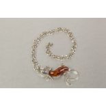 SINGLE STRAND NECKLACE OF GOLDEN AMBER CHIPS AND TWO METAL CHAIN NECKLACES, with large pendant set