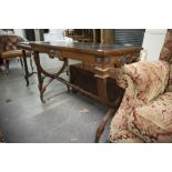 A MAHOGANY SIDE/WRITING TABLE WITH 'C' SHAPED LEGS, TURNED CROSS STRETCHER, WITH THREE INSET PADS TO