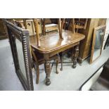 AN OAK DRAW-LEAF DINING TABLE, RAISED ON CUP AND COVER TURNED SUPPORTS WITH SALTIRE STRETCHER AND