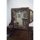 A VICTORIAN FIRE SCREEN, OAK FRAME WITH NEEDLEWORK SCENE OF A SEATED WOMAN READING