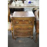 A SMALL THREE DRAWER CHEST WITH SLIDE-OUT WRITING SECTION, RAISED ON CABRIOLE LEGS