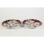 PAIR OF JAPANESE LATE MEIJI PERIOD IMARI PORCELAIN PLATES, each of slightly dished form with wavy