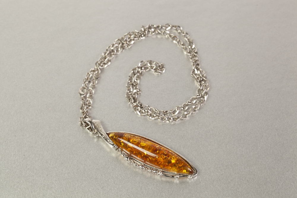 SINGLE STRAND NECKLACE OF GOLDEN AMBER CHIPS AND TWO METAL CHAIN NECKLACES, with large pendant set - Image 2 of 3