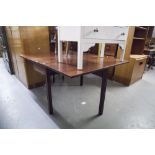AN ANTIQUE MAHOGANY DROP LEAF DINING TABLE