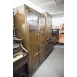 AN OAK THREE PIECE BEDROOM SUITE, COMPRISING; A TALLBOY, A DRESSING TABLE, WITH SHAPED MIRROR OVER