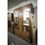 A VICTORIAN BEDROOM SUITE OF THREE PIECES VIZ, A TRIPLE WARDROBE WITH MIRRORS TO EACH DOOR, TWO