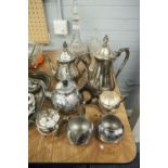 A SILVER PLATE TEA/COFFEE SERVICE OF FOUR PIECES AND ANOTHER OF THREE PIECES