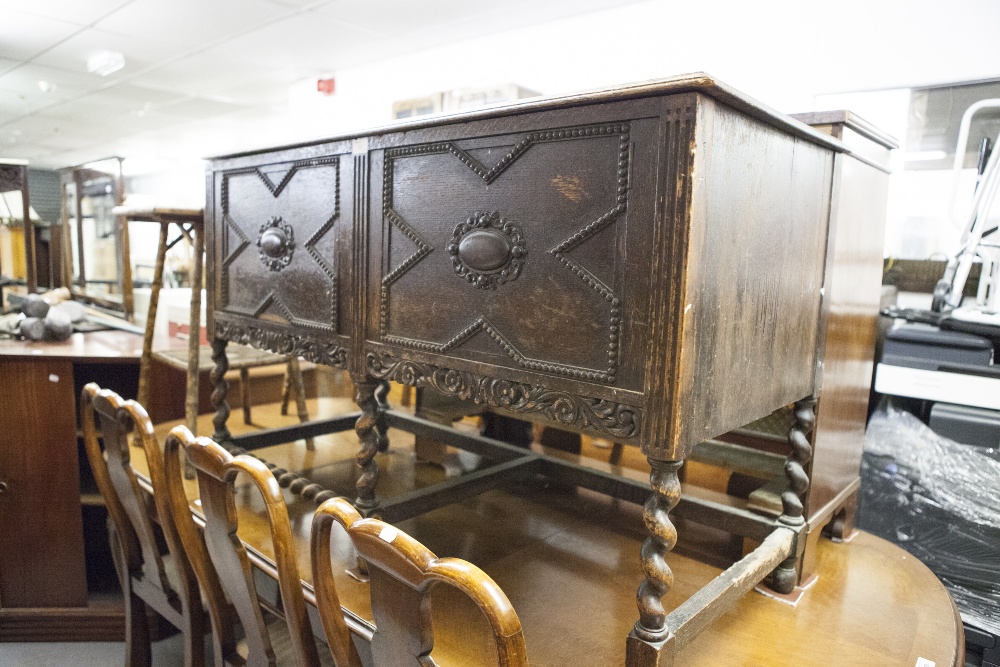 A DARK OAK SIDEBOARD CIRCA 1930's WITH TWO DOOR CUPBOARD 'X' BEAD DETAIL, PIERCED FLORAL PEDIMENT,