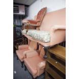 PRE-WAR COTTAGE STYLE WINGED LOUNGE SUITE OF THREE PIECES, RECOVERED IN PINK FABRIC, ON CARVED
