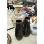 A LARGE ORIENTAL POTTERY VASE AND TWO BLACK AND GILT DECORATED GLASS VASES (3)