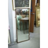 AN OBLONG WALL MOUNTED ROBING MIRROR WITH PLAIN MAHOGANY FRAME