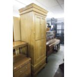 A SOLID PINE SINGLE DOOR WARDROBE WITH DRAWER BELOW