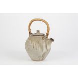 ANCHOR POTTERY, ST. IVES, TEAPOT, of ovoid form with bamboo handle, glazed in matt tones of grey and