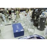 SIX VARIOUS SQUARE, ROUND GLOBE AND SHAFT GLASS DECANTERS; A WATERFORD CRYSTAL CANDLE HOLDER, IN