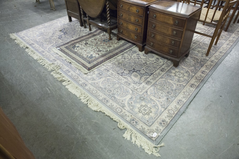 BORDERED WILTON CARPET OF PERSIAN DESIGN, with large circular centre medallion within an oval