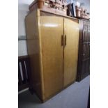 AN ART DECO BIRDSEYE MAPLE AND WALNUT DOUBLE GENTLEMAN'S WARDROBE, SOLID DOORS AND SHAPED HANDLES