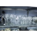 A CUT GLASS TABLE SERVICE, INCLUDING; TUMBLERS, STEM GLASSES IN 3 SIZES, BRANDY BALLOONS, GLASSES (