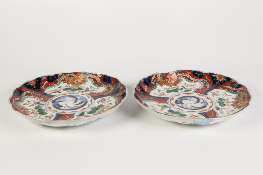 PAIR OF JAPANESE LATE MEIJI PERIOD IMARI PORCELAIN PLATES, each of slightly dished form with wavy