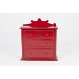 VICTORIAN RED PAINTED STATIONARY BOX WITH WRITING SLOPE IN THE FORM OF A MINIATURE CHEST OF DRAWERS,